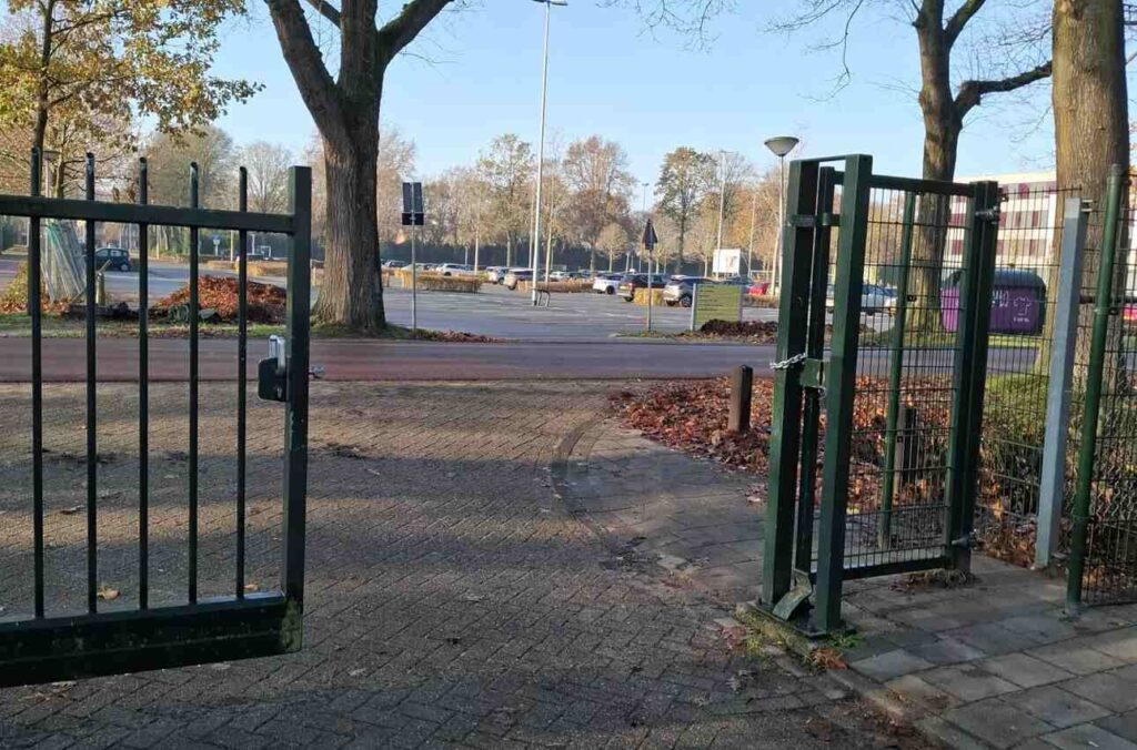 Rechts naast de -geopende- poort de nieuwe fietssluis bij hockeyclub HC Eindhoven.